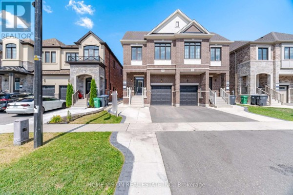 Street view of a row of townhouses in Brampton, with driveways and manicured lawns. - 36 Quinton Ridge, Brampton