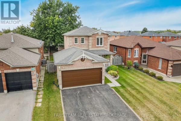 Aerial view of a two-story brick house with a double garage and surrounding properties. - 36 Red Oak Drive, Barrie