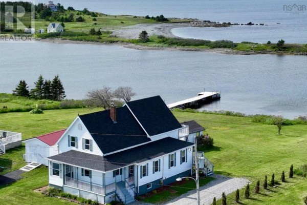 Aerial view of the house with a parking area and surrounding properties - 36 Seaview Drive, Gabarus Village