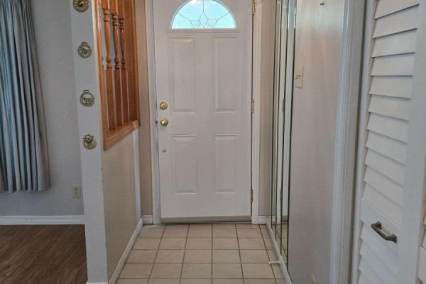 Interior view of the front door with tiled floor and mirrored closet. - 36 Weeping Willow Drive, Innisfil
