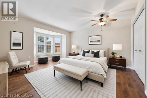 Primary bedroom with a bay window, hardwood floors, ceiling fan, and closet. - 360 Erbsville Road Unit# 18, Waterloo