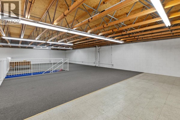 Upper level area with carpeted flooring and exposed wooden beams. - 360 Spedding Court Unit# 4, Kelowna