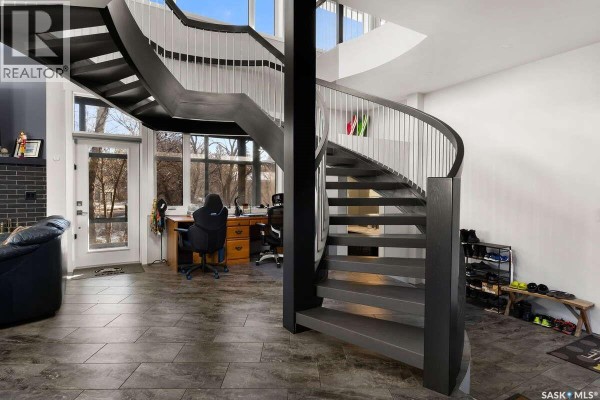 Sleek kitchen appliances with dark cabinetry and built-in microwave - 3601 Grassick Avenue, Regina