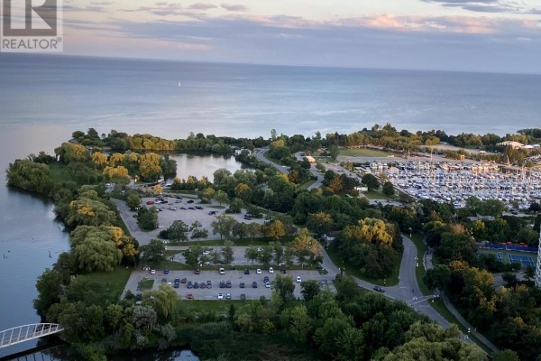 Aerial view of a waterfront park with a lake, marina, and car park. - 3606 - 2212 Lakeshore Road W, Toronto