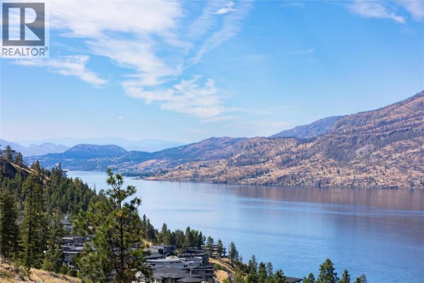 Expansive view of Okanagan Lake and surrounding hills from a high vantage point. - 3608 Sagehill Court, Kelowna