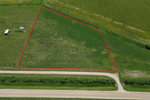 Aerial view of a large, irregular-shaped green field outlined in red, next to a road and agricultural land. - 36106 Mun 48n Road, Dufresne