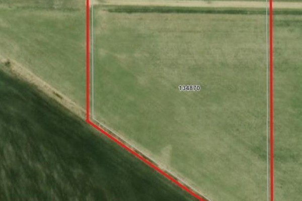Close-up aerial view of a green field with lot number 134870 visible, bordered by a red line. - 36106 Mun 48n Road, Dufresne