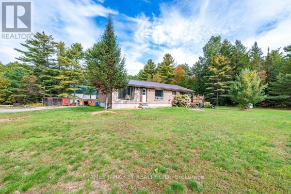 A single-story house with stone and brick exterior, partially screened porch, and deck. - 36148 Highway 17 Highway, Laurentian Hills