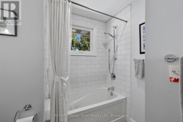 Bathtub with subway tile, shower head, and window - 3625 Alnwick Hill Road Hamilton Township