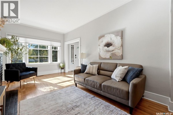 Bedroom with hardwood flooring, wall-mounted TV, and neutral-colored walls - 363 Leopold Crescent, Regina