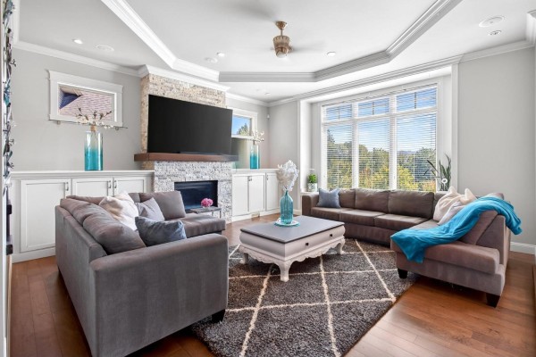 Dining area with a round table, chairs, a large window with a view, and hardwood floors. - 36497 Carnarvon Court, Abbotsford