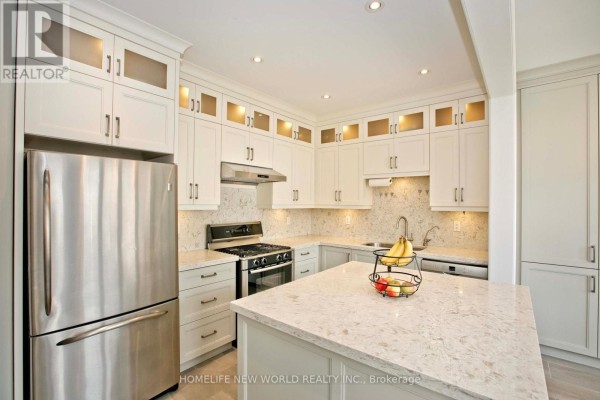 Close-up view of the modern kitchen with stainless steel appliances, white cabinetry, and quartz countertops. - 365 Tonelli Lane, Milton