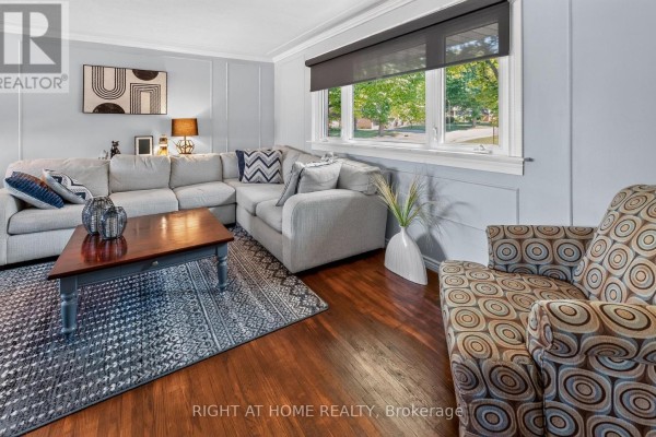 Living room with a sectional sofa, patterned armchair, wooden coffee table, and patterned rug. - 366 Burlington Crescent, London South