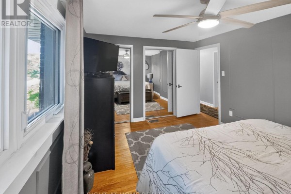Bedroom with ceiling fan & mirrored closet doors - 366 Burlington Crescent London South