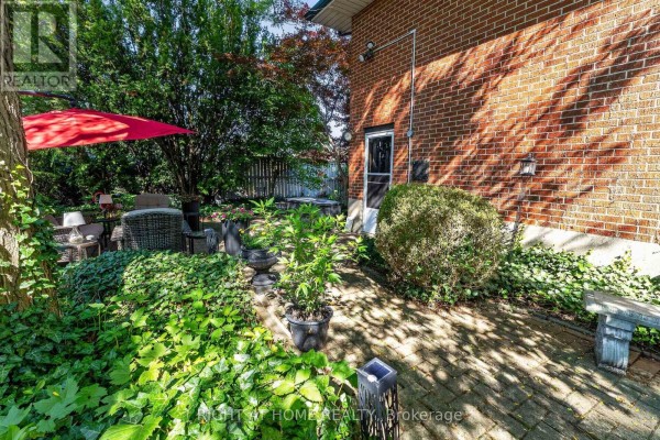 Brick patio with outdoor seating and red umbrella - 366 Burlington Crescent London South