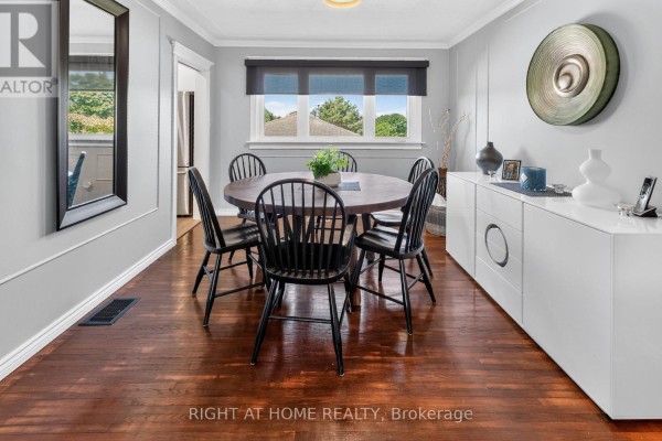 Round dining table with black chairs and a white buffet - 366 Burlington Crescent London South