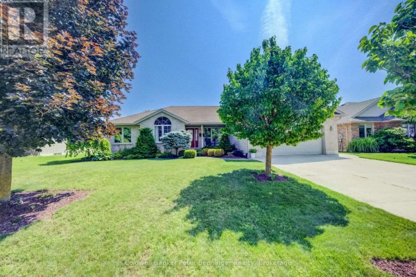 Front view of a brick bungalow with a large tree casting a shadow on the lawn. - 366 Westwood Drive, Brockton