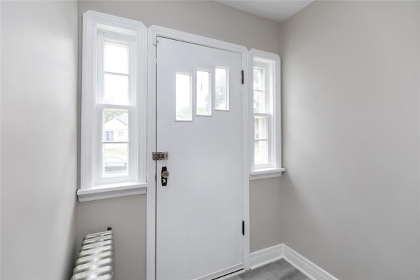 Interior view of a white front door with three glass panels and two side windows. - 367 Jamison Avenue, Winnipeg