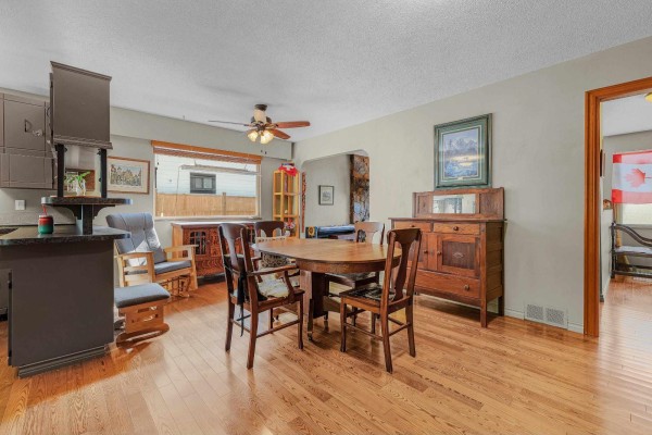 Dining room adjacent to the kitchen, featuring a wooden table and chairs, and a buffet. - 3670 207b Street, Langley
