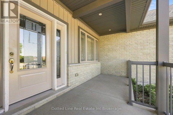 Close-up of the beige front door and beige brick exterior of the bungalow. - 3677 59 Highway, Norfolk