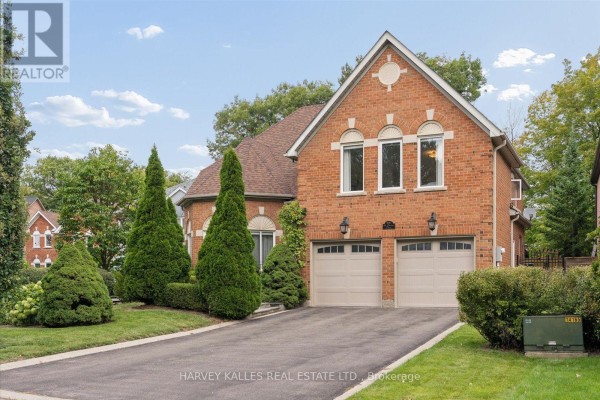 Brick house with manicured landscaping and a paved driveway on a sunny day. - 3685 St. Laurent Court, Mississauga