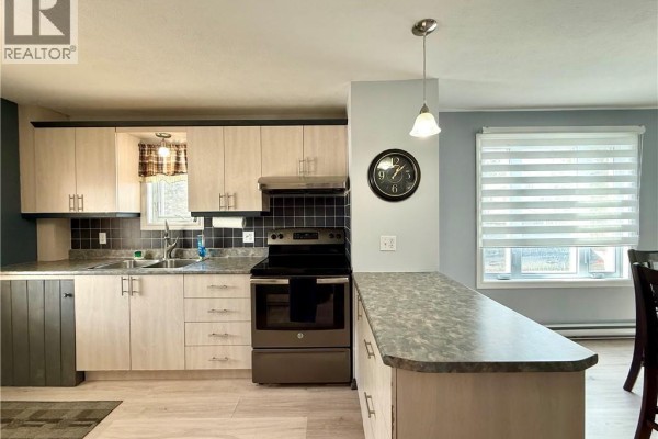 Close-up of kitchen featuring light wood cabinets and black backsplash - 3688 Principale Street, Baker Brook