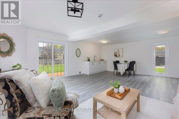 Open concept living and dining area with a kitchenette and backyard view. - 369 Lake Drive, Georgina