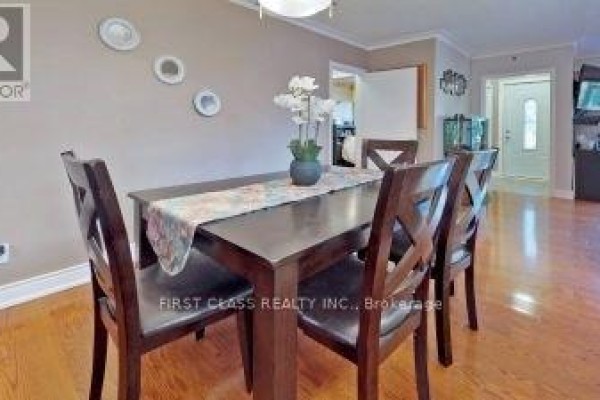 Wooden dining table with four chairs, set for a meal, with beige walls. - 369 Paliser Crescent S, Richmond Hill