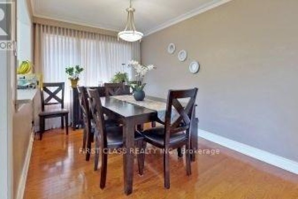 Dining area with dark wood table and chairs, view of curtains and decorative plates. - 369 Paliser Crescent S, Richmond Hill