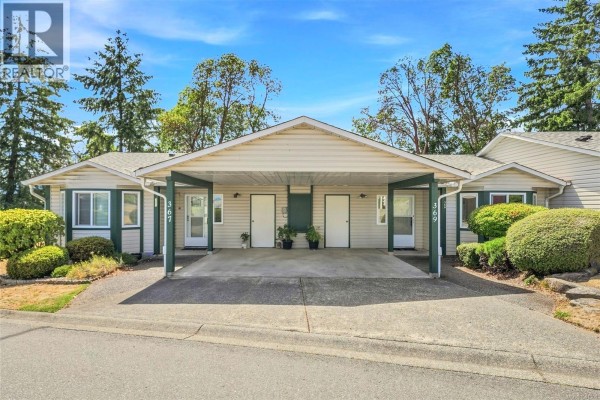 Front view of two connected townhouse units, each with a private entrance and carport. - 369 Petroglyph Cres, Nanaimo