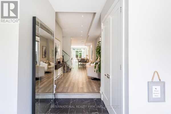 Modern hallway with mirror, console table, and open concept living/dining - 36b Pine Avenue Mississauga