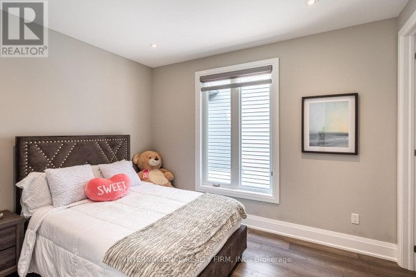 Bedroom with tufted headboard, teddy bear, and artwork - 36b Pine Avenue Mississauga