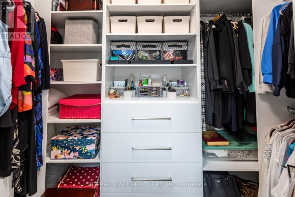 Organized closet with drawers, shelves, bins, and hanging clothes - 36b Pine Avenue Mississauga