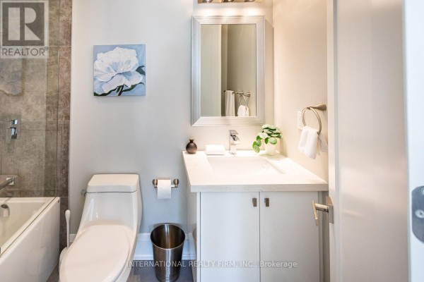 Modern bathroom with vanity, toilet, bathtub, and wall art - 36b Pine Avenue Mississauga