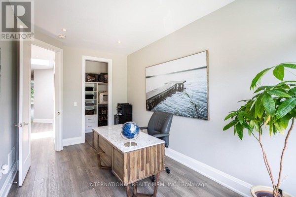 Office with wooden desk, globe, and wall art - 36b Pine Avenue Mississauga