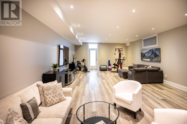 Living room with sofa, TV, exercise equipment, and coffee table - 36b Pine Avenue Mississauga