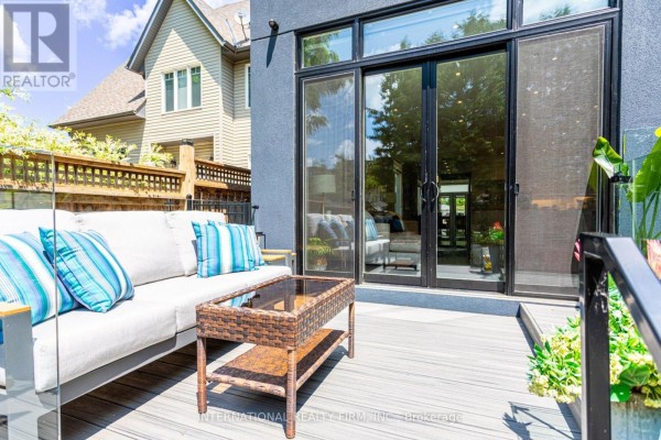 Modern deck patio with sofa and coffee table, sliding glass doors - 36b Pine Avenue Mississauga