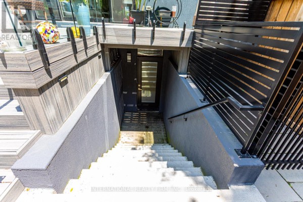 Modern concrete stairs to glass door with composite decking and metal fence - 36b Pine Avenue Mississauga
