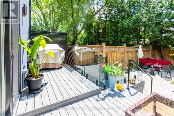 Modern deck with glass railing, outdoor seating, hot tub, and BBQ - 36b Pine Avenue Mississauga