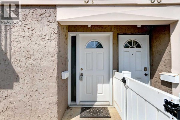 Close-up of two white front doors with arched glass panes and mailbox fixtures. - 37, 3015 51 Street Sw, Calgary