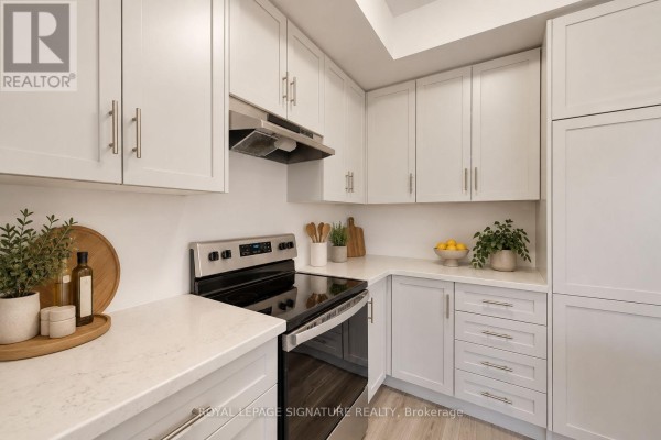 L-shaped kitchen with white cabinets, quartz countertops, and stainless steel appliances. - 37 - 10 Birmingham Drive, Cambridge