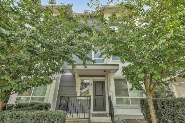 Front entrance of a townhouse with a grey door, number 37, and surrounding trees. - 37 12830 62 Avenue, Surrey
