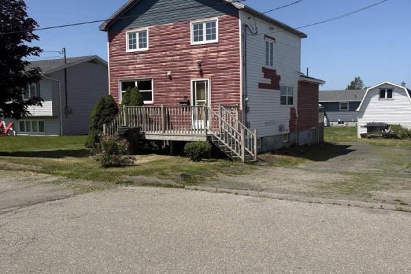 Front and side view of a two-story house with red and white siding, deck, and driveway. - 37 Bennett Street, Grand Lake Road