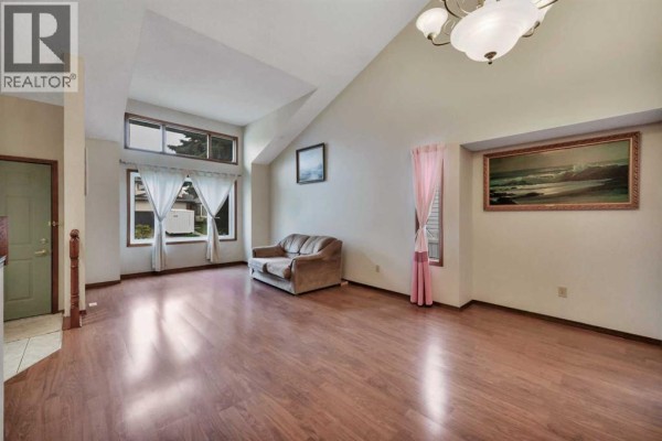 Finished basement room with grey carpet and neutral walls. - 37 Denovan Crescent, Red Deer