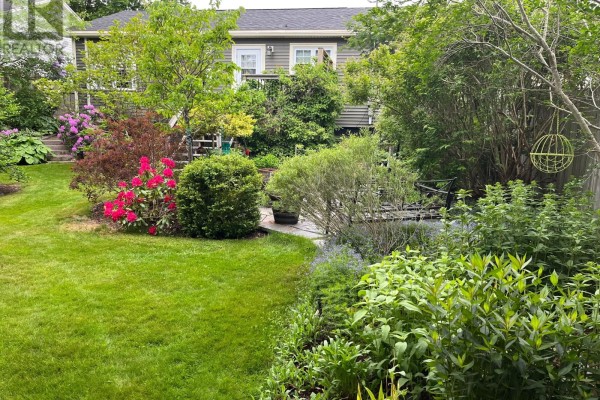 A small patio table with two chairs on a wooden deck, offering a private seating area. - 37 Gleneyre Street, St  John S