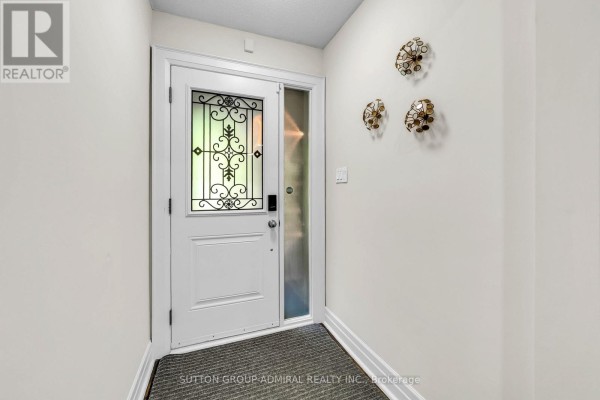 Interior view of a white front door with decorative glass and wall sconces. - 37 Gretman Crescent, Markham