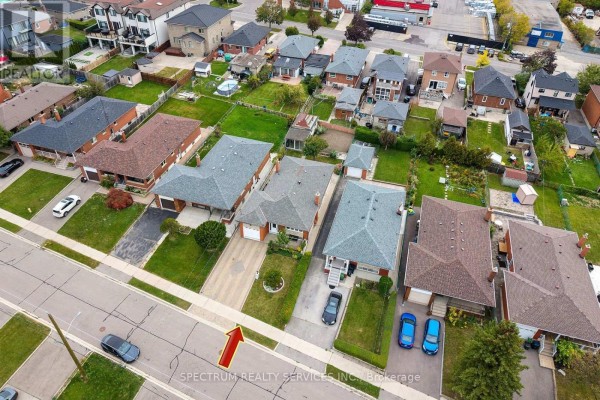 Aerial view of several houses on a street, with cars parked in driveways and on the road. - 37 Jocada Road, Toronto