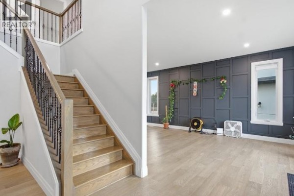 Open-concept kitchen featuring a large island, white cabinetry, and stainless steel appliances. - 37 Kingsbridge Drive, Amherstburg