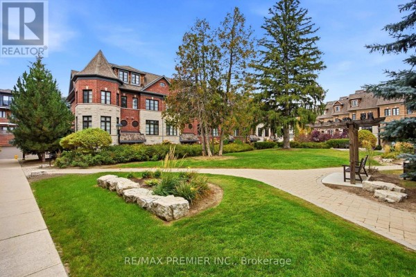 Aerial view of a brick townhouse complex with mature trees and landscaping in front. - 37 Nease Lane, Vaughan