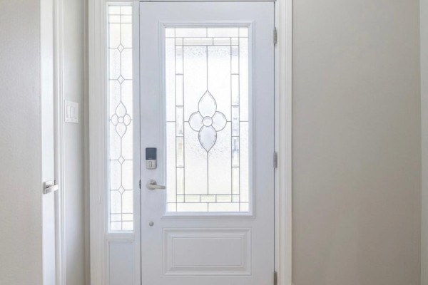 Interior view of a bright white front door with frosted glass panels and a keypad lock. - 37 Sewells Lane S, Brampton